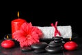 Beautiful spa concept of red hibiscus flower with dew, candles a Royalty Free Stock Photo