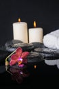 Beautiful spa concept of zen stones with drops, purple orchid Royalty Free Stock Photo