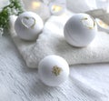Beautiful spa cosmetic composition. Close up bath bombs, towel on white background.
