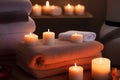 Beautiful spa setting with candles and hot stones on wooden background. Beauty wellness center treatment and relax concept. Royalty Free Stock Photo