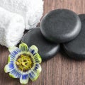 Beautiful spa still life of passiflora flower, black zen stones Royalty Free Stock Photo