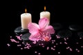 Beautiful spa still life of pink hibiscus, candles, zen stones Royalty Free Stock Photo