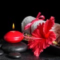 Beautiful spa still life of red hibiscus flower with dew, candle Royalty Free Stock Photo