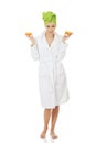 Spa woman in bathrobe holding orange. Royalty Free Stock Photo