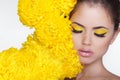 Beautiful Spa Woman over chrysanthemum flowers. Eyes makeup. Beauty Portrait. Perfect Fresh Skin. Pure Beauty Model Girl.