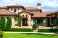 Beautiful Spanish style house exterior with natural rock facing and veneer siding