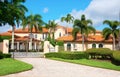 Beautiful Spanish style luxury mansion residential home with a privacy gate and palm trees