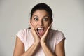 Beautiful Spanish surprised woman amazed in shock and surprise happy and excited