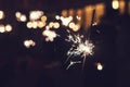 Beautiful sparkler firework flame on black background. Bright bengal lights spark in the darkness. Night firework flick. Blurred l Royalty Free Stock Photo