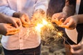 Beautiful sparklers in people hands, xmas and new year concept.