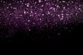 Beautiful, sparkling purple glitter pouring down from above on a dark background