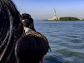 Beautiful and spectacular photograph of people watching from a boat the famous and fabulous Statue of Liberty.