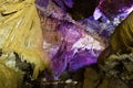 Beautiful speleothem stalagnata, stalactites, stalagmites in natural cave illuminated by color lights