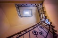 Beautiful spiral staircase, going upstairs, with decorative metallic handrails in ancient house