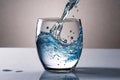 A beautiful splash of blue transparent liquid pouring into a glass. Clean drinking pure water concept Royalty Free Stock Photo