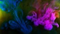 Beautiful splash of multicolored ink mixing in water. Stock footage. Streams and explosions of beautiful colored ink in