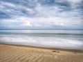 A beautiful splashing swash silky smooth water reflection on beach.