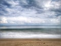 A beautiful splashing swash silky smooth water reflection on beach.