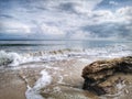 A beautiful splashing swash silky smooth water reflection on beach.