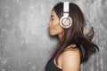 Beautiful sport woman with big white headphones. Model listening the music. Fitness portrait, perfect body shapes