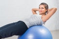 Beautiful sport woman doing fitness exercise, stretching on ball. Pilates, sports, health.