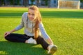 Beautiful sport woman doing stretching fitness exercise in city park at green grass. Yoga postures Royalty Free Stock Photo