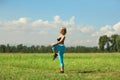 Beautiful sport woman doing stretching fitness exercise in city park at green grass.