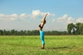 Beautiful sport woman doing stretching fitness exercise in city park at green grass. Royalty Free Stock Photo