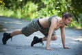 Beautiful sport woman training push-ups in park