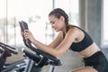 Beautiful sport woman working out on exercise bike at sport health club Royalty Free Stock Photo