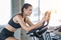 Beautiful sport woman working out on exercise bike at sport health club Royalty Free Stock Photo