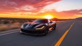 A beautiful sports car driving against a dramatic sunset sky