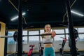 Beautiful sports fitness girl with a barbell. Sporty woman exercising with barbell in gym Royalty Free Stock Photo