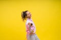 Beautiful sportsgirl with skipping rope isolated on yellow studio Royalty Free Stock Photo