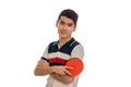 Beautiful sportsman practicing a table tennis with racket in hands and looking at the camera isolated on white