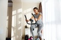 Beautiful sporty woman cycling a bike at home. Cardio training, exercising legs, Cardio workout at home Royalty Free Stock Photo