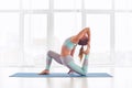 Beautiful sporty fit yogi woman practices yoga asana King Pigeon pose rajakapotasana at the yoga studio Royalty Free Stock Photo