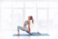 Beautiful sporty fit yogini woman practices yoga asana Ashva Sanchalasana - equestrian pose at the yoga studio Royalty Free Stock Photo