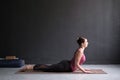 Beautiful sporty fit yogini woman practices yoga asana bhujangasana