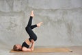 Beautiful sporty fit young woman doing yoga. Model doing shoulder stand exercise, asana Viparita Karani, Upside-Down Seal pose.