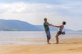 Beautiful sporty mature couple dancing on the beach on the Volga river against the background of the Zhiguli mountains Royalty Free Stock Photo