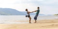 Beautiful sporty mature couple dancing on the beach on the Volga river against the background of the Zhiguli mountains Royalty Free Stock Photo