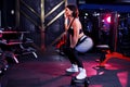 Beautiful sporty sexy middle woman doing squat workout in gym Royalty Free Stock Photo