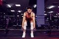 Beautiful sporty sexy woman in cap doing squat workout in gym Royalty Free Stock Photo