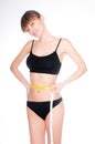 Beautiful sporty woman body with yellow measure on white background Royalty Free Stock Photo