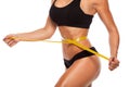Beautiful sporty woman body with yellow measure on Royalty Free Stock Photo