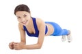 Beautiful sporty woman doing core exercise on the floor