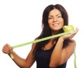 Beautiful sporty woman with green apple and measuring tape Royalty Free Stock Photo