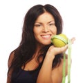 Beautiful sporty woman with green apple and measuring tape Royalty Free Stock Photo