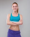 Beautiful sporty woman smiling with arms crossed Royalty Free Stock Photo